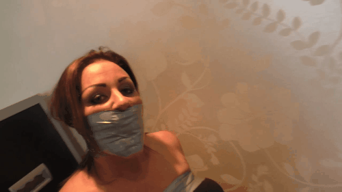 Redheaded Woman Tightly Bound And Tape Gagged