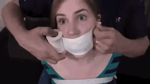 Whining girl has her mouth tape wrap gagged shut