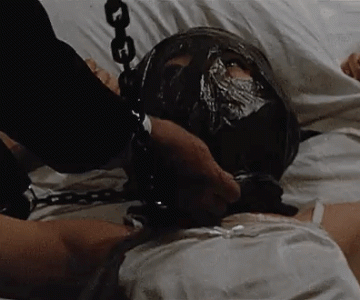 Japanese woman ball gagged and chained in bed