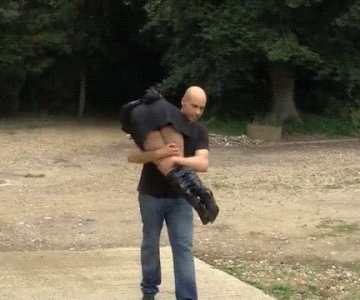 Bound and gagged woman is carried over the shoulder by a man