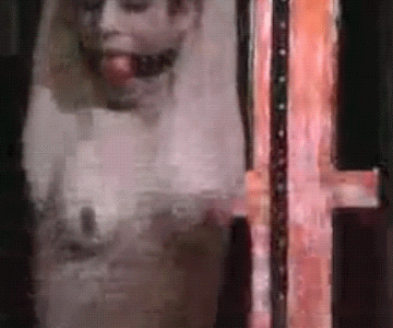 A hardcore BDSM gif showing a strung up woman ball gagged and nude. She gets her tits flogged and she is in pain