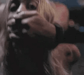 This gif shows a blonde girl fucked with the guy's hand over her mouth