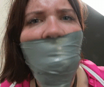 Heavily tape gagged woman tries to talk with her mouth stuffed.